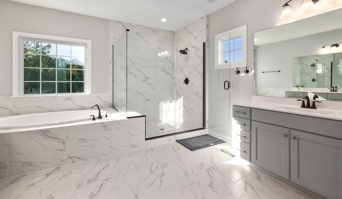 Classic bathroom remodel in Auburn, CA featuring a freestanding tub, white subway tile, marble vanity top, and brushed nickel fixtures.
