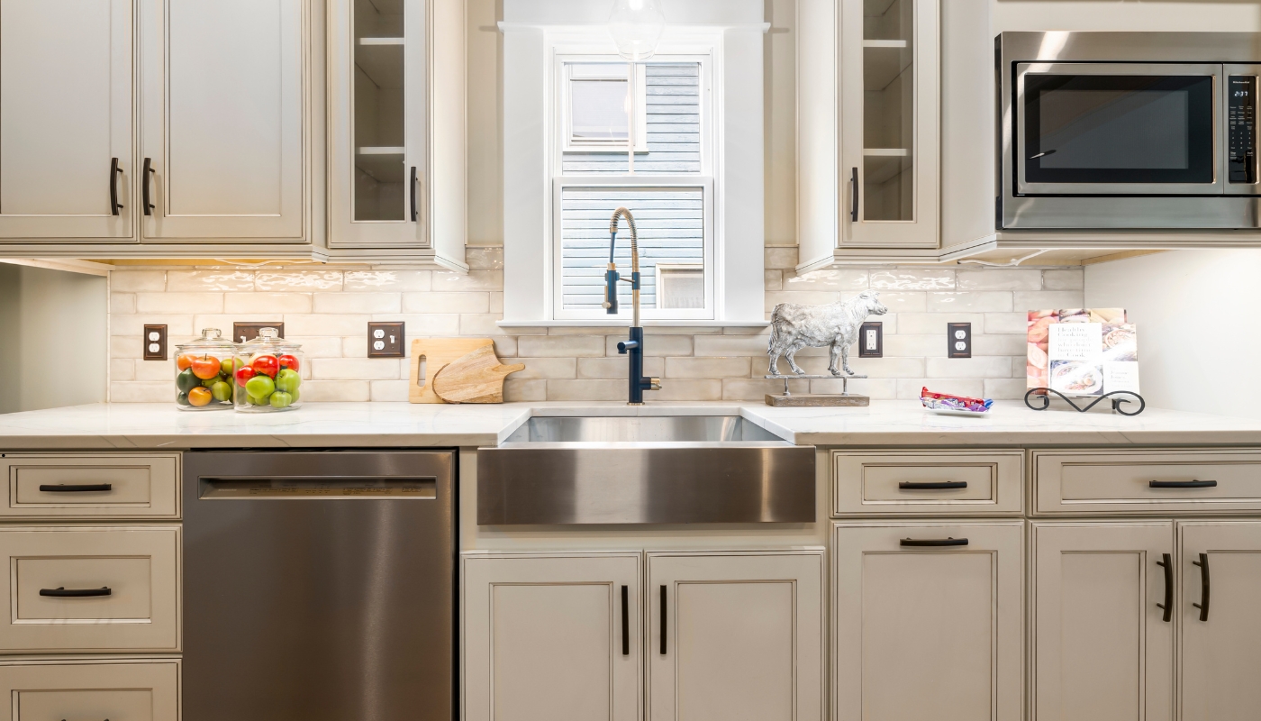 A classic kitchen design with shaker cabinets, marble countertops, and warm lighting showcasing timeless remodeling style in Davis, CA.