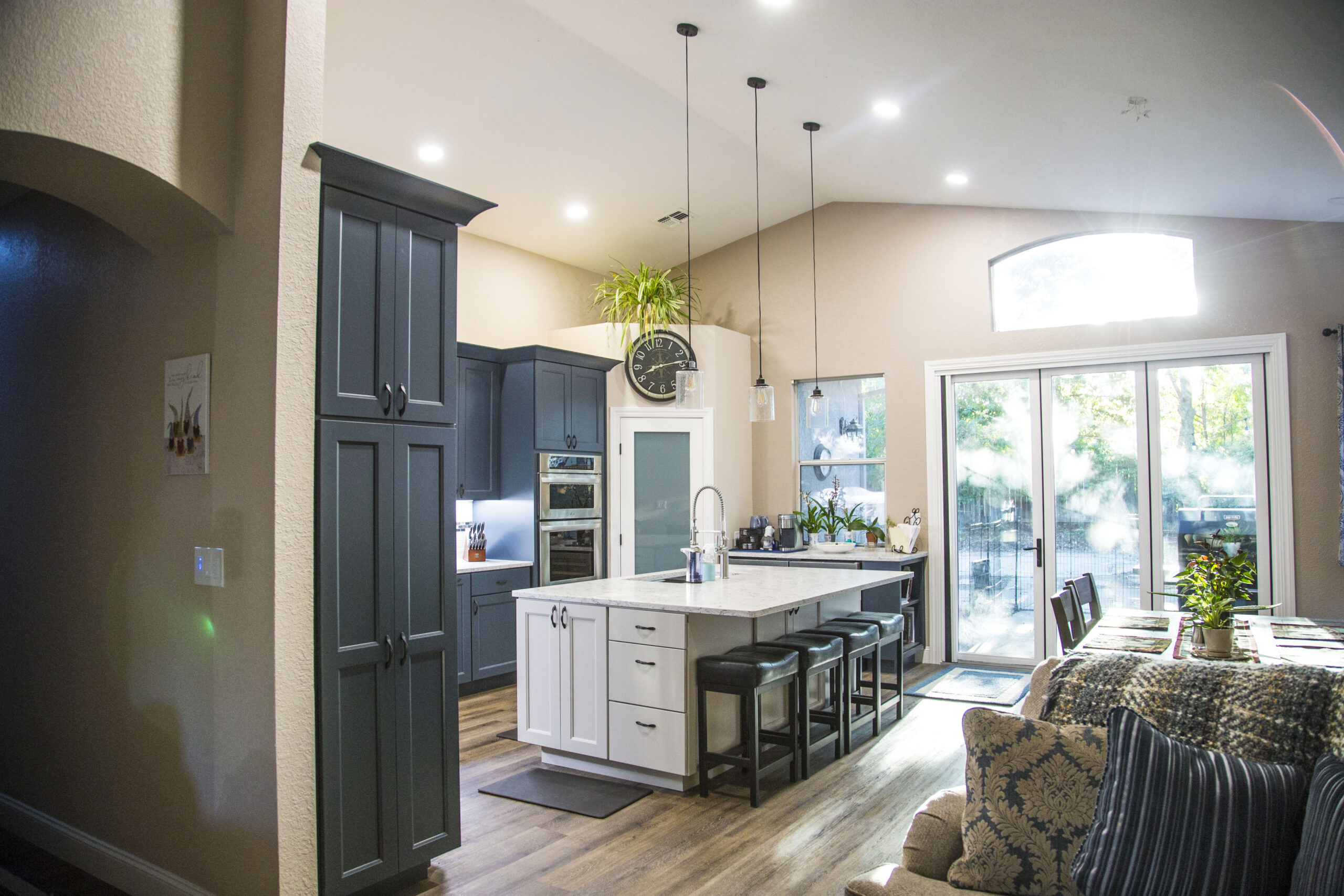 Elegant classic kitchen remodel in Citrus Heights, CA featuring white shaker cabinets, quartz countertops, subway tile backsplash, and pendant lighting.