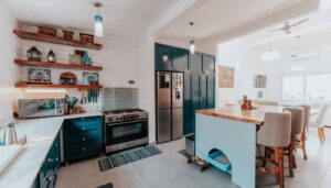 A beautifully remodeled classic kitchen in Auburn, CA featuring white shaker cabinets, marble countertops, and timeless design by Remodel California.