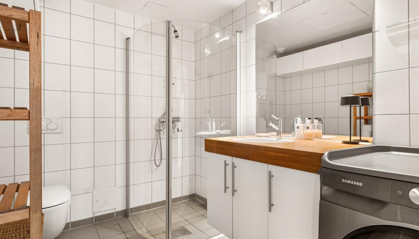 Modern luxury bathroom remodeled by Remodel California showcasing elegant tile, glass shower, and custom vanity