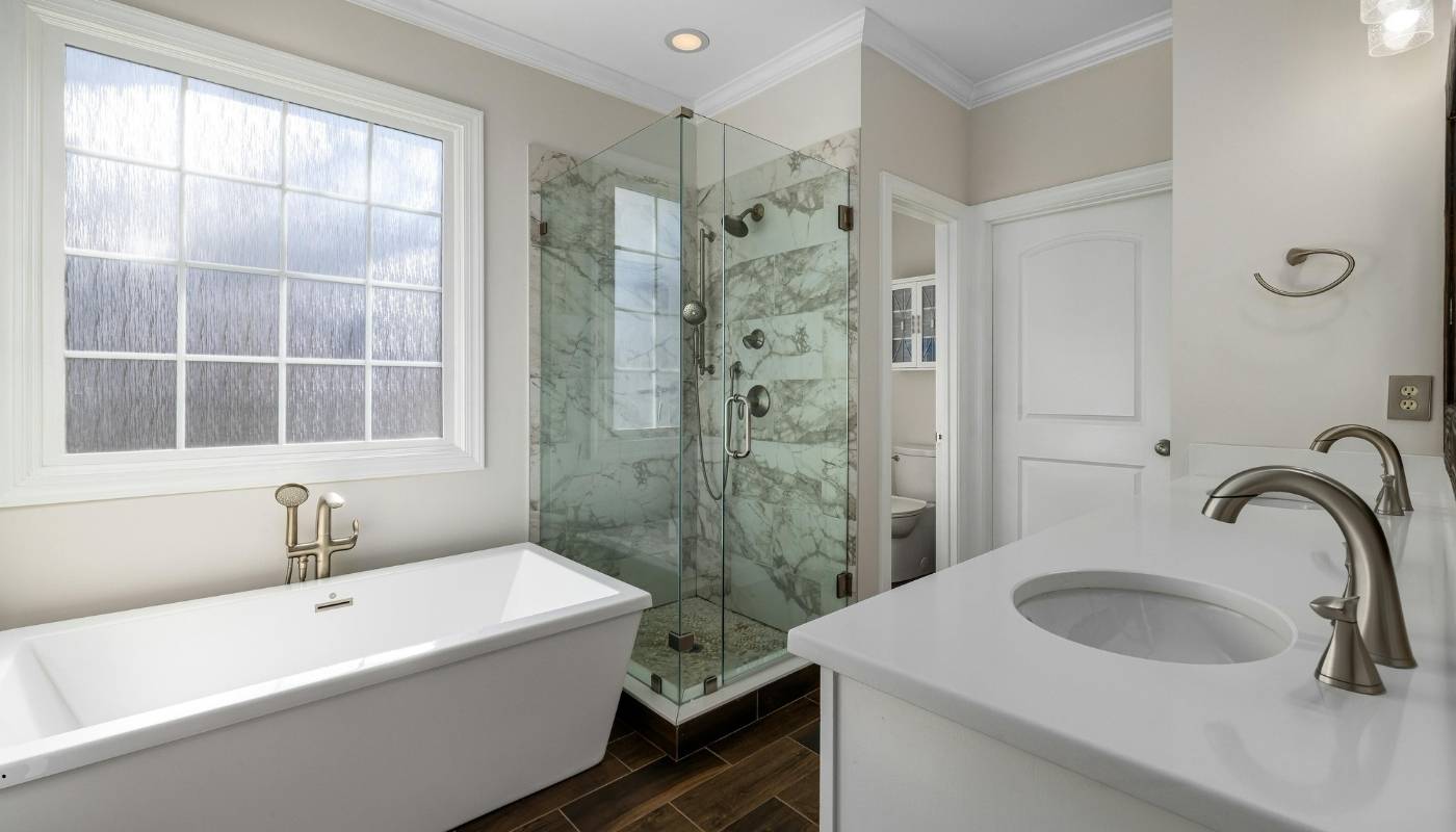 Elegant luxury bathroom renovation in Lincoln, California featuring custom cabinetry, marble countertops, and frameless glass shower designed by Remodel California